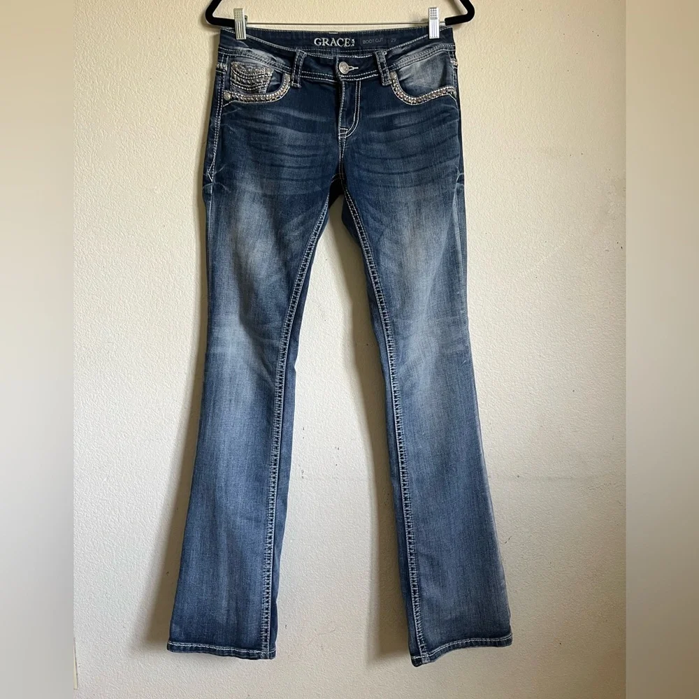 Grace in LA bootcut blue jeans with sequin and embroidery designs. Women’s 29